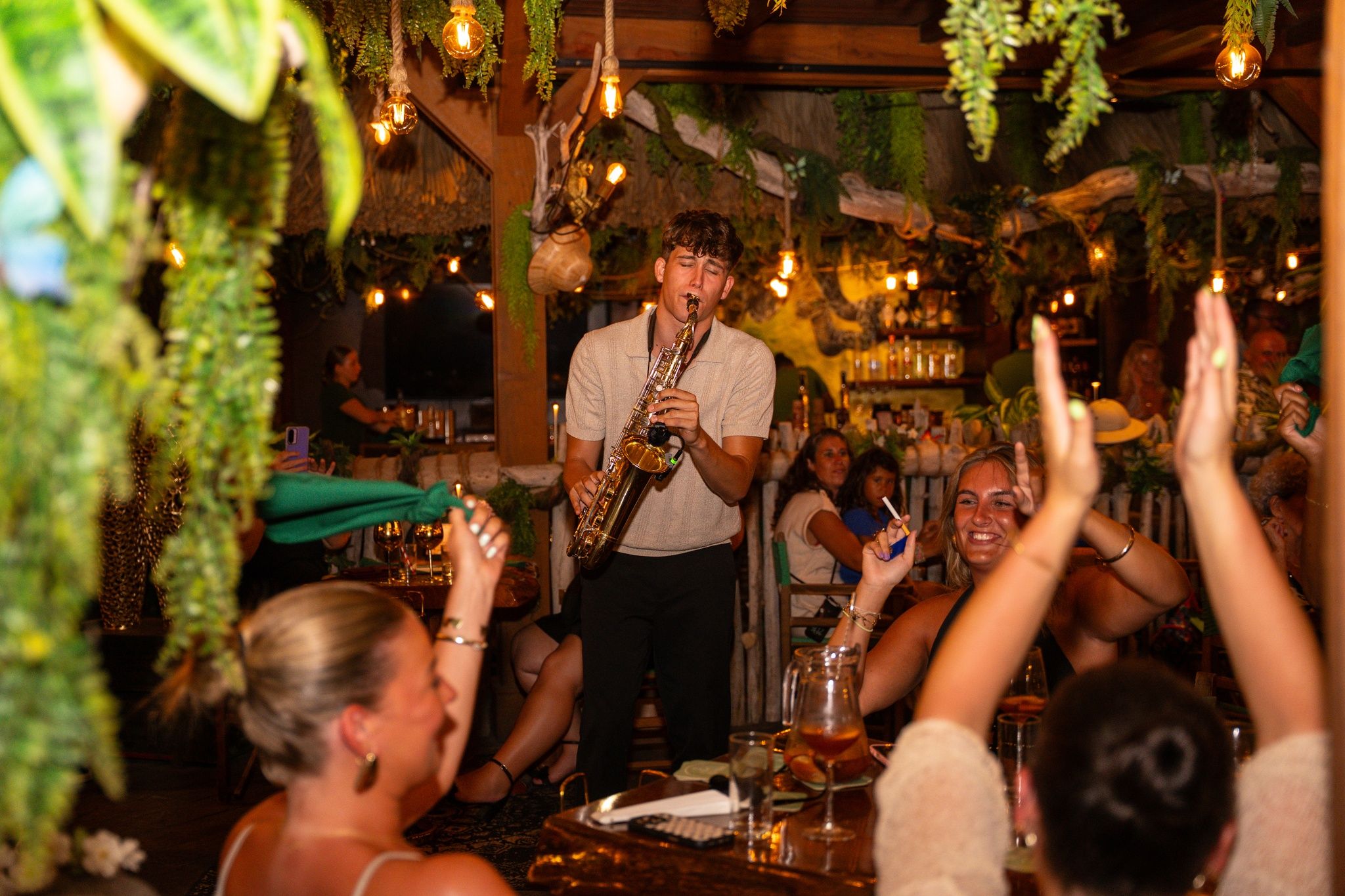 Kian Kazàn performing in a restaurant surrounded by cheering guests